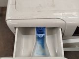 a toothbrush in the drawer of a washing machine