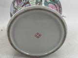 a white cup with a picture of a house on it