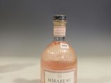 an image of a bottle of pink wine sitting on a table