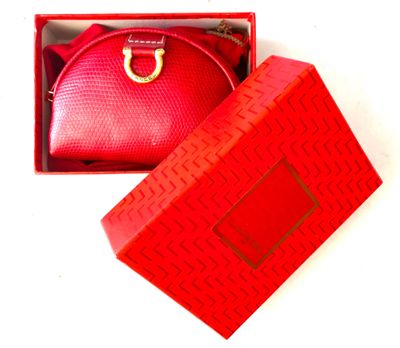 a red box with a red purse inside of it