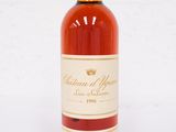 a bottle of wine sitting on top of a white table