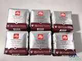 six packets of coffee sitting on top of each other on a table