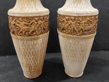two vases that are sitting on a black surface