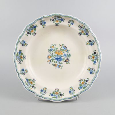a blue and white plate with a floral design on the rim