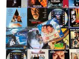 many different movie posters on the wall of this room