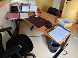 a desk with a chair and a computer on it