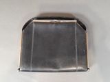 a black purse sitting on a white surface