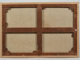 a close up of a wooden frame with a window in the middle