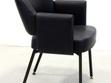 a black chair that is sitting on a white floor
