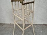 a white chair that has a magazine rack on it