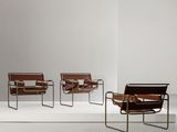 three chairs in a white room with a white floor and a white wall