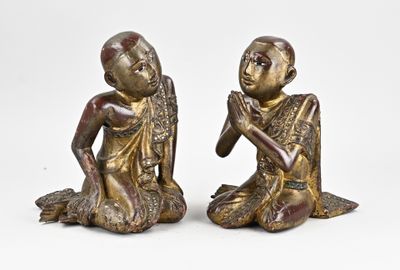 pair of bronze figurines of a boy and a girl sitting on the ground