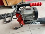 a red and black electric blower sitting on the floor