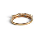 an image of a gold ring on a white surface