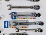 many wrenches that are lined up together on the table