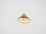 a gold ring with an emerald stone in the center
