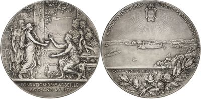 two silver medals with a picture of a woman and a man on them