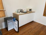 an image of a small kitchen with a refrigerator