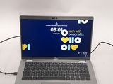 a laptop that is connected to a charger on the table