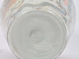 a white vase with a floral design on it