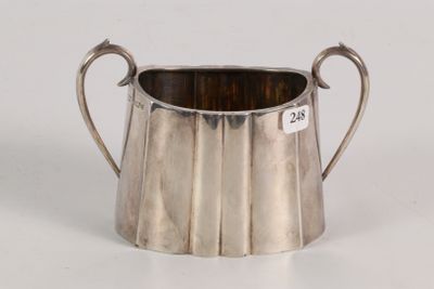 an image of a silver cup with a handle on a white surface