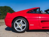 the red sports car is parked on the side of the road
