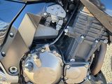a close up of a motorcycle parked on the side of the road