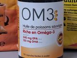 a bottle of omega 3 fish oil next to a packet of omega 3 fish oil