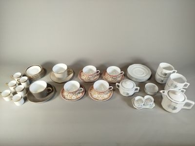 many cups and saucers sitting on a table