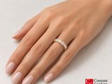 the hand of a woman with a diamond ring on her finger
