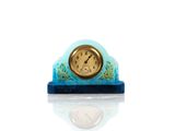 a small clock that is sitting on top of a table