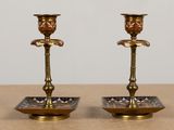 pair of antique brass candlesticks on a table