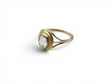 an image of a gold ring with a clear quartz stone