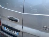 a silver van that is parked on the side of the road