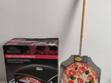 a pizza and a pizza cutter sitting next to each other