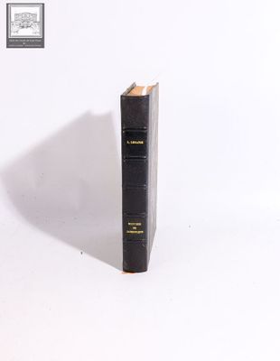 a black book that is sitting on a white surface