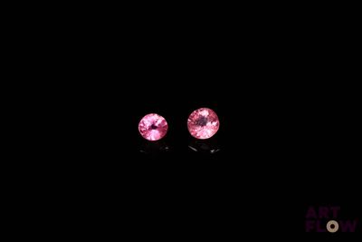 une paire de saphirs roses sur fond noir