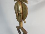 statue of a man with a helmet on his head on a wooden base