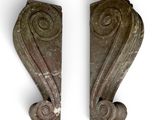 pair of carved wood corbs with spiral designs on each side