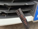 a ruler on the front of a car that is parked on the street