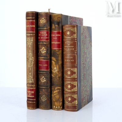 three books are stacked on top of each other on a white surface