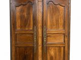 an old wooden armoire with two doors and two drawers
