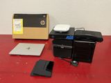 a laptop, a hard drive, and a hard drive on a red table