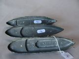 three small boats that are sitting on a table