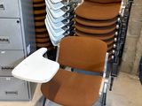 a lot of chairs and a filing cabinet in a room