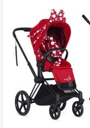 the stroller is red and white with polka dots on it
