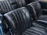 an image of a black leather seat in a classic car