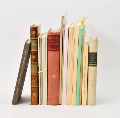 several books are stacked on top of each other on a white surface