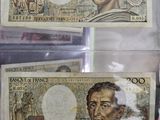 three different bank notes are in a clear plastic case