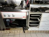a stove with pots and pans on it in a kitchen